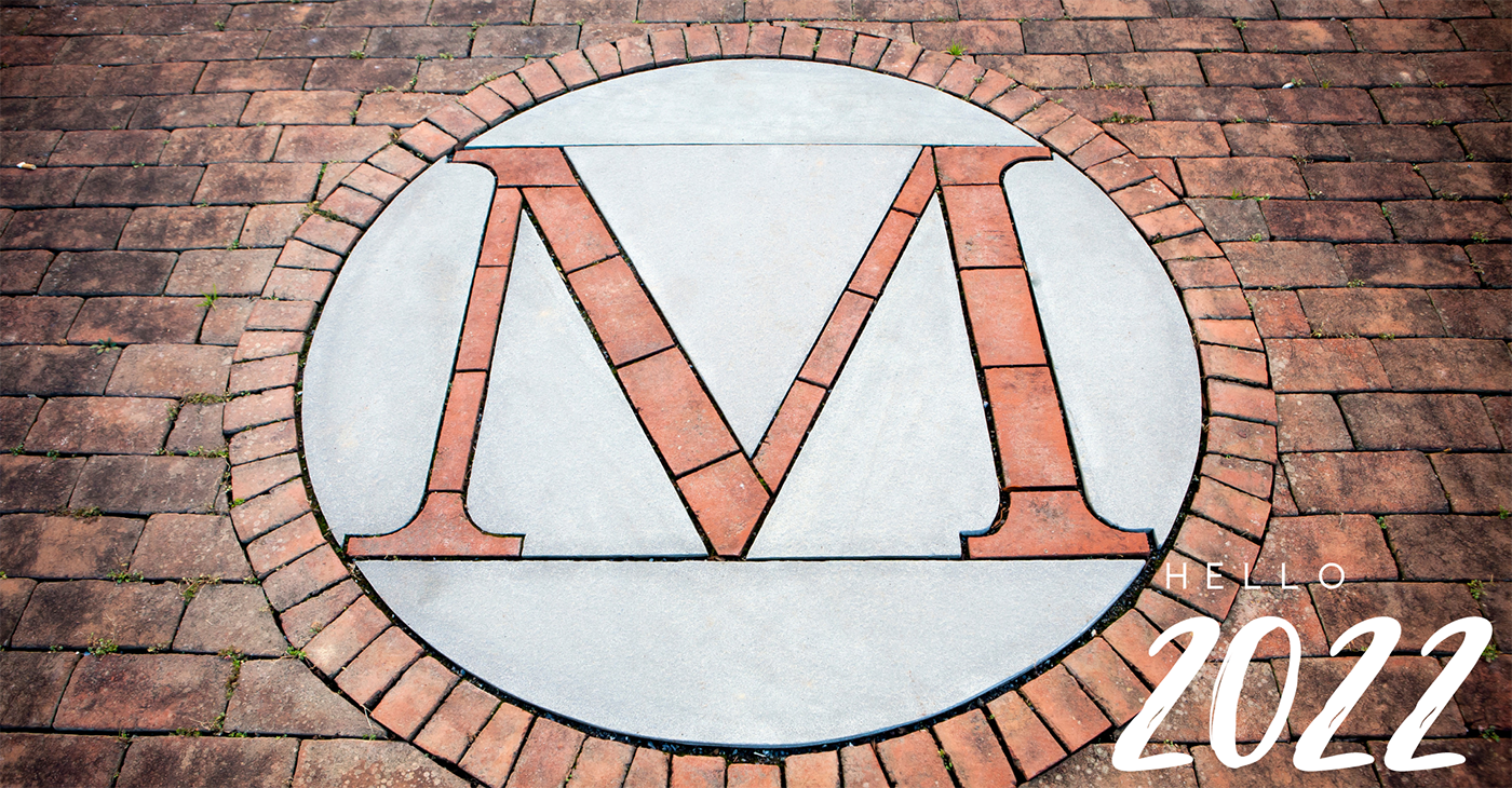 M symbol on brick floor